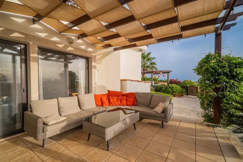 Large sectional sofa on the patio inviting guests to relax and enjoy the garden and the views.
