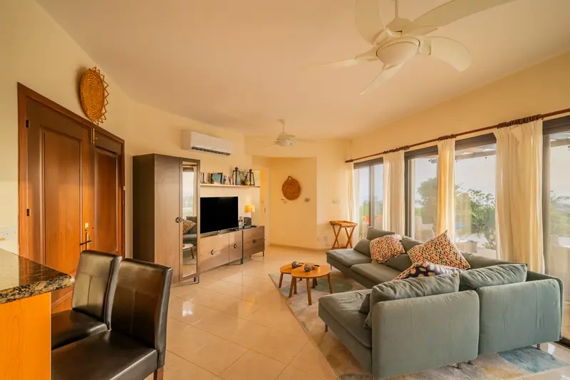 Living room space with a comfortable sofa. The entrance to the bedroom wing of the villa is on the right in the picture.