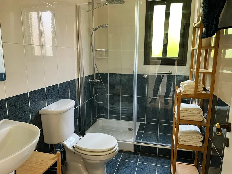 Full bathroom with walk-in rain shower and heated towel rails. Ensuite to the master bedroom.