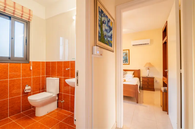 Full bathroom with a tub/shower combo and heated towel rails connected to the hallway.
