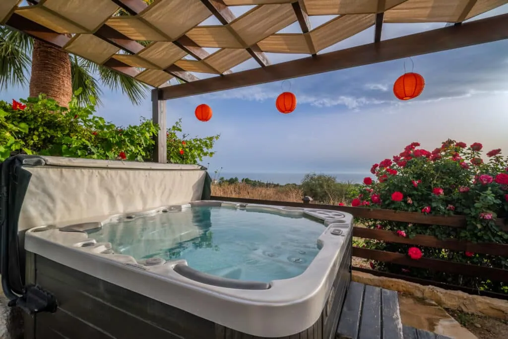 Hot tub under wooden pergola